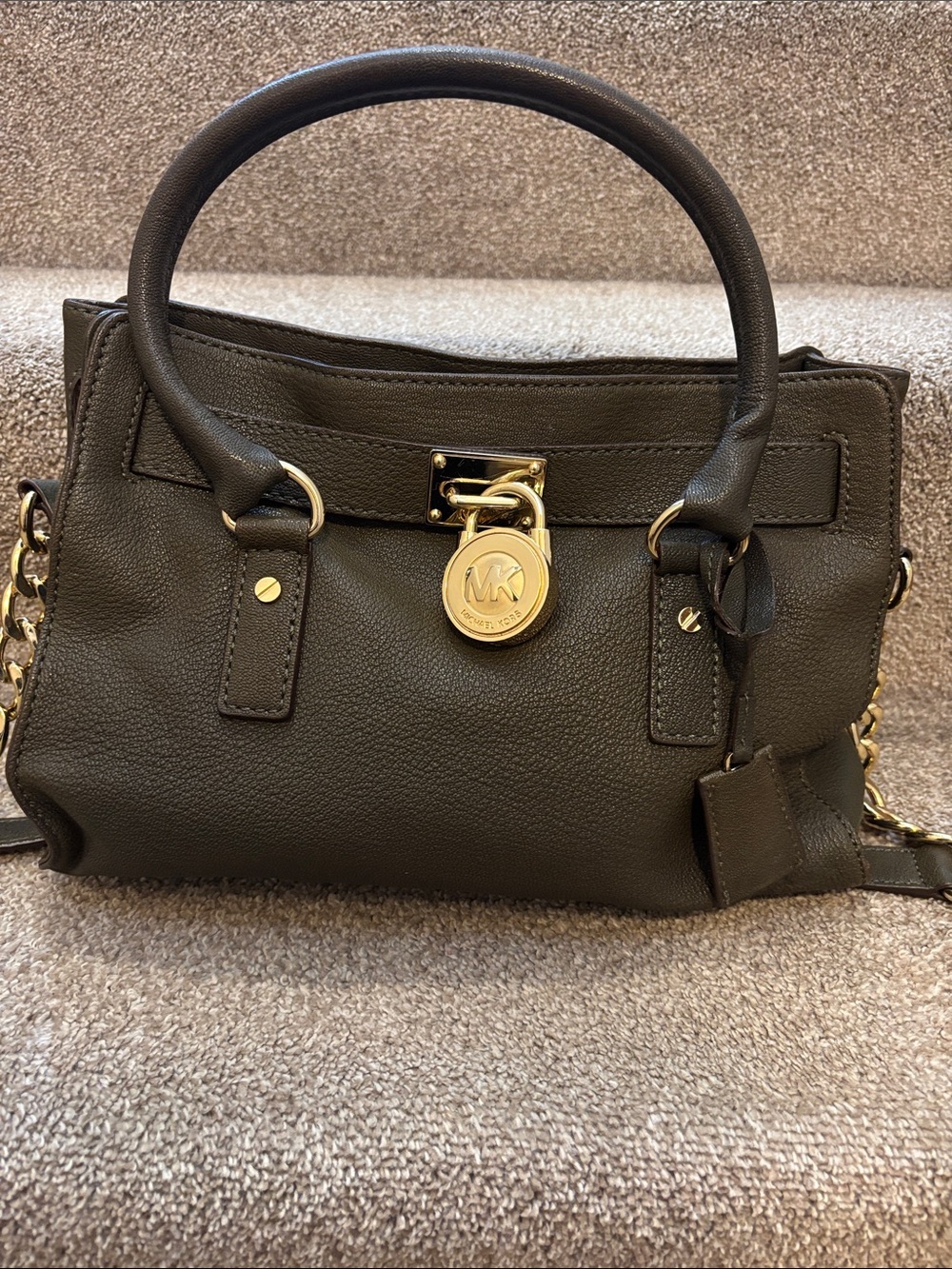 This is a Michael Kors Hamilton bag in a dark green shade.